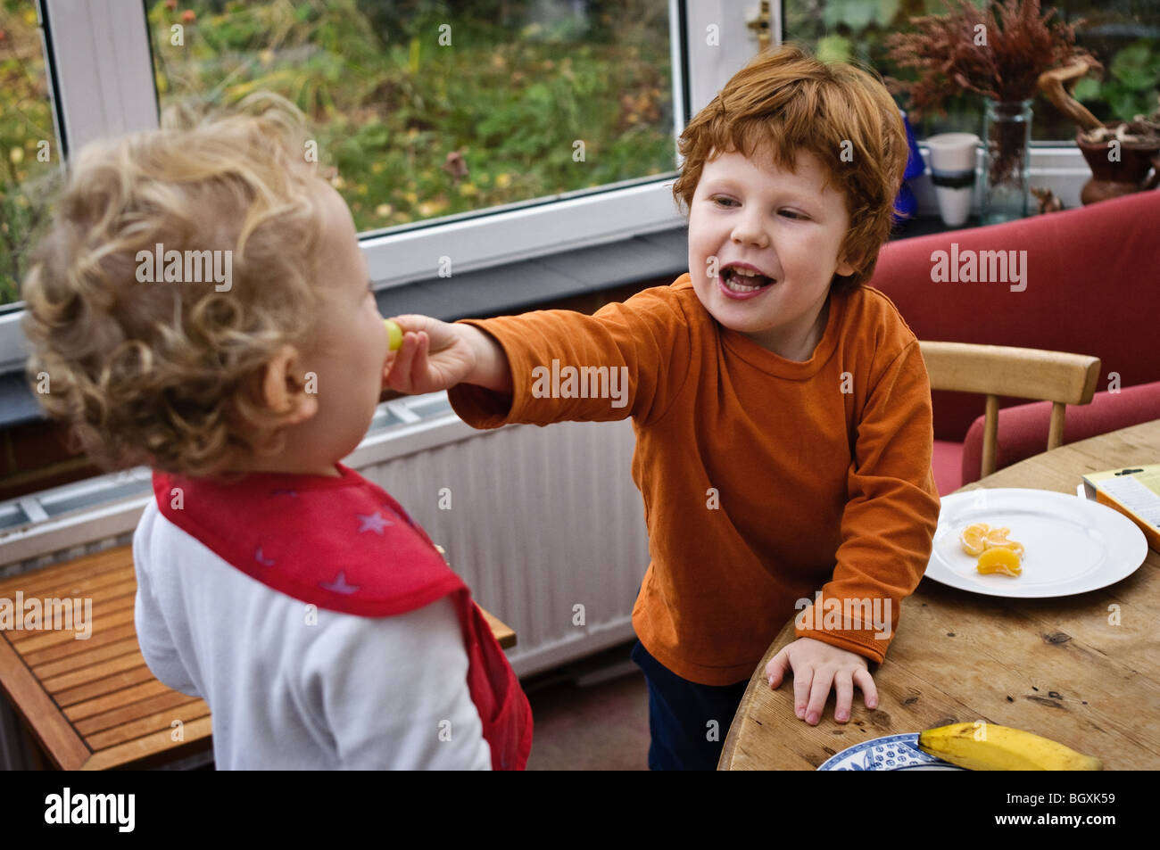 Two brothers eating breakfast Stock Photo Alamy