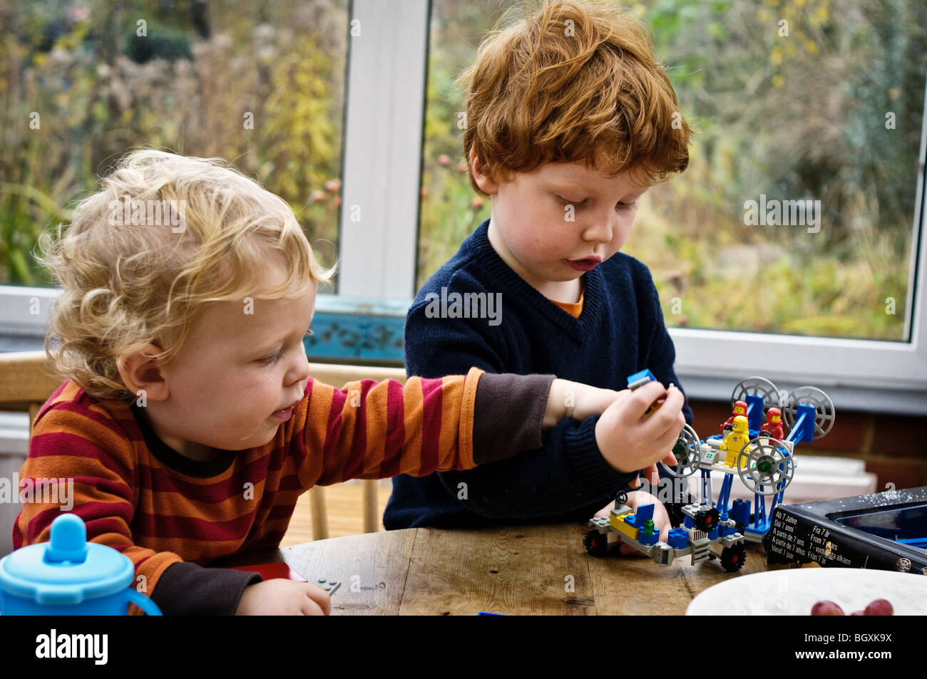 Two brothers playing with Lego building toy. Stock Photo