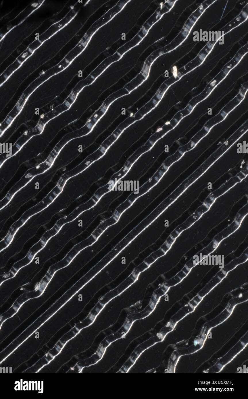 The grooves on a 45RPM stereo single vinyl record photographed at 25x resolution Stock Photo