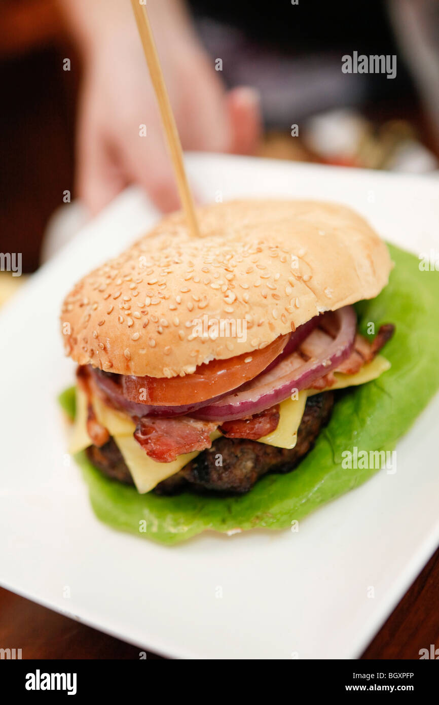 Burger served on a plate in a restaurant Stock Photo