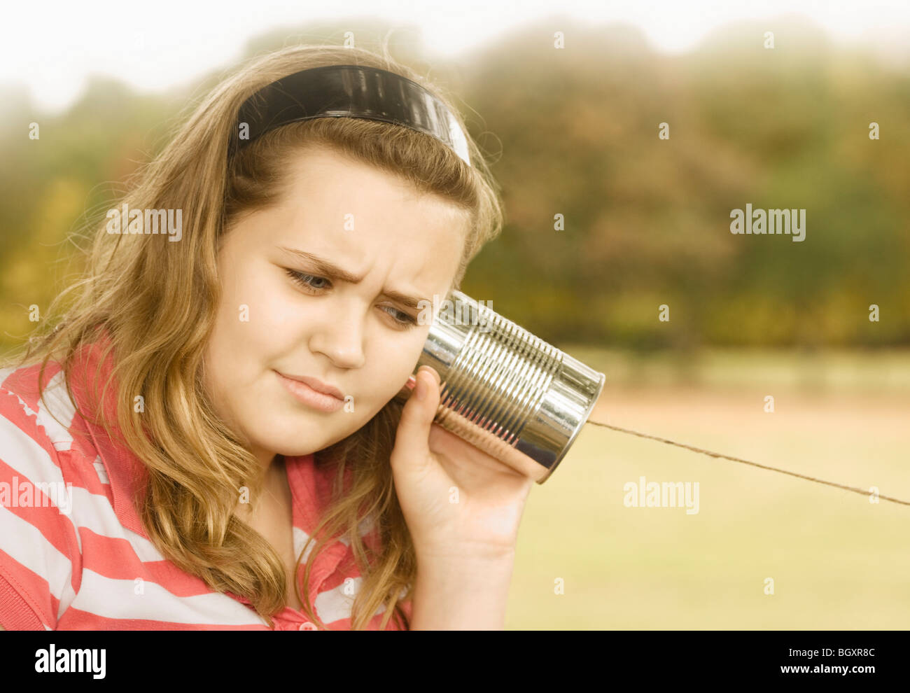 Girl Listening to Tin Can Phone Stock Photo Alamy