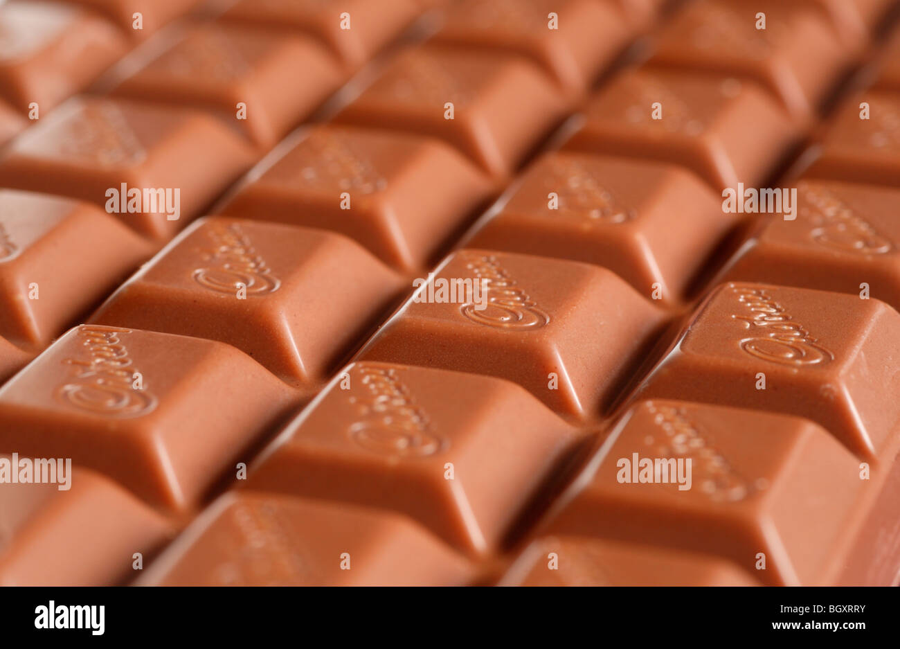 A bar of Cadbury's milk chocolate, featuring the Cadbury's logo. Stock Photo