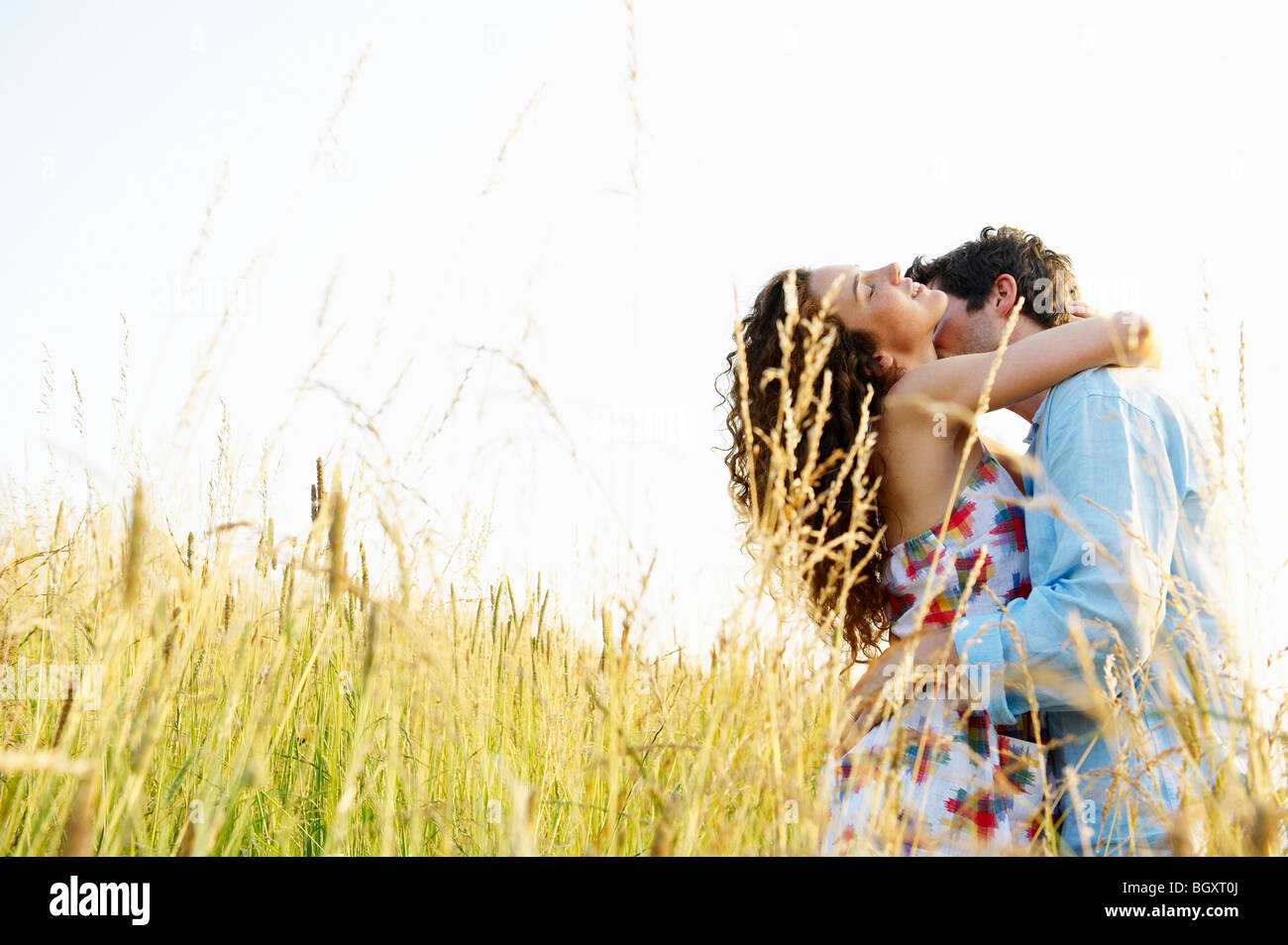 Couple kissing in a wheat field Stock Photo