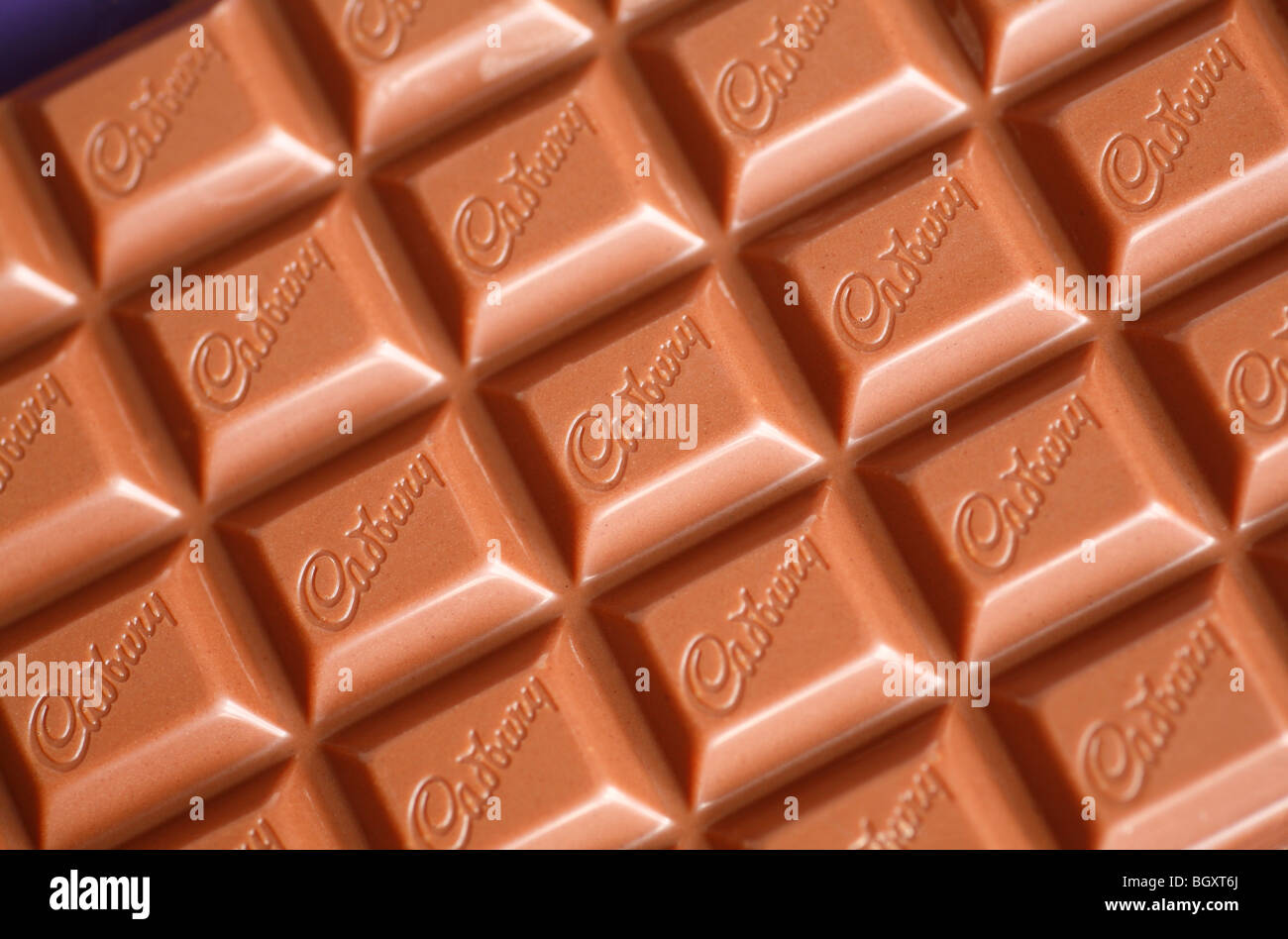 A bar of Cadbury's milk chocolate, featuring the Cadbury's logo. Stock Photo