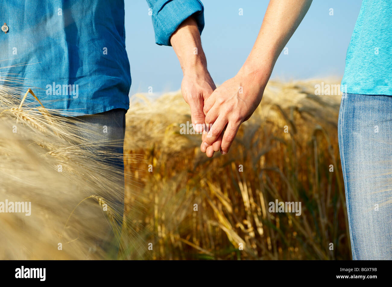 Couple holding hands in nature hi-res stock photography and images - Alamy