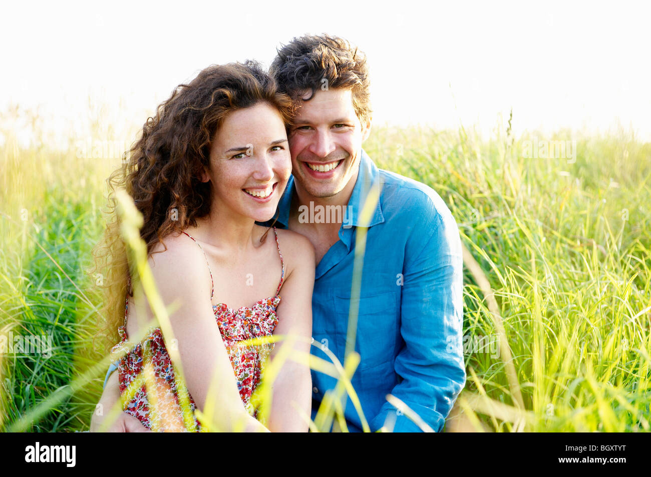 Couple smiling in a wheat field Stock Photo - Alamy