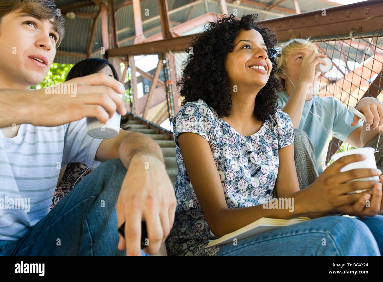 Young woman hanging out with friends watching sports event Stock Photo