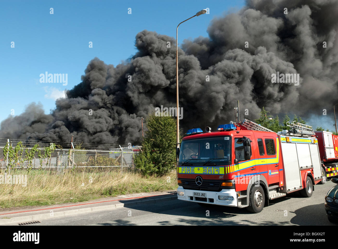 Huge industrial fire with large plumes of thick black smoke against ...