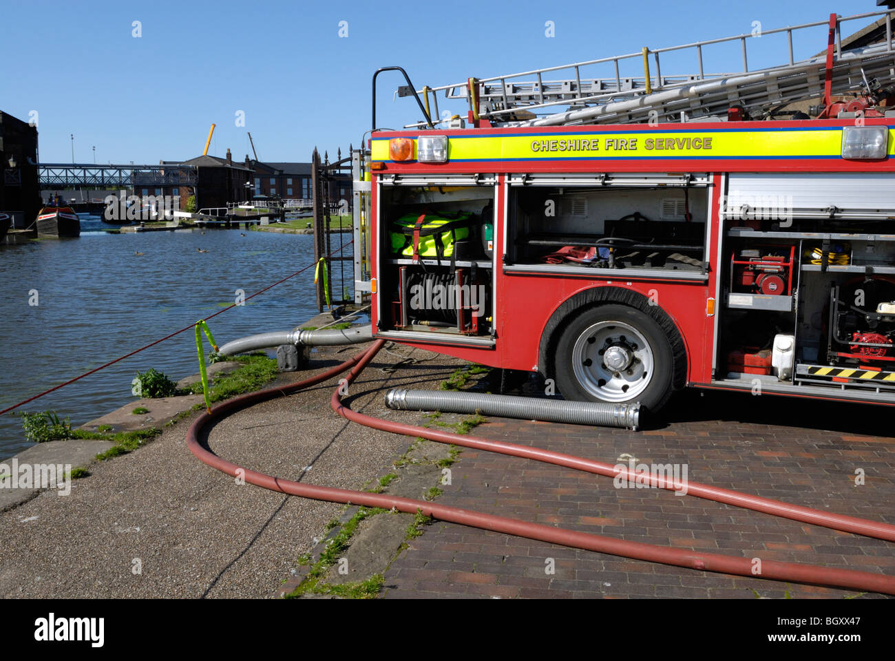Fire engine pumping water from open canal Stock Photo Alamy