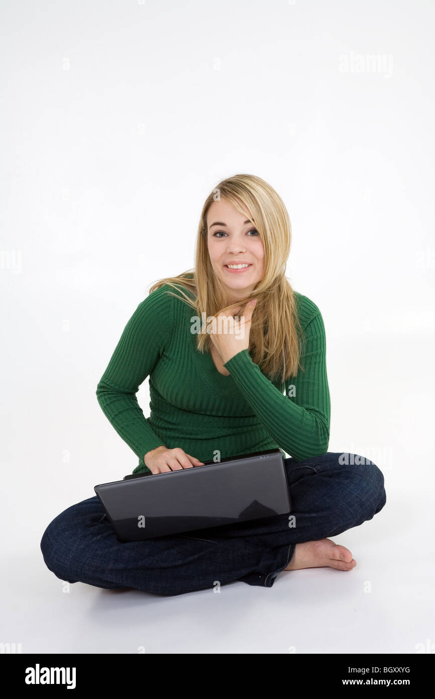 Young woman working on laptop computer on white background Stock Photo ...