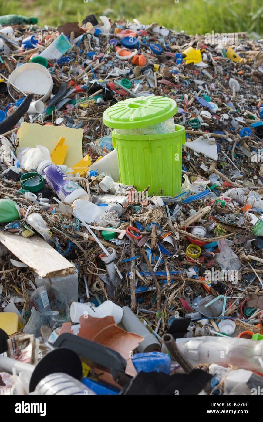Full garbage can in midst of landfill Stock Photo