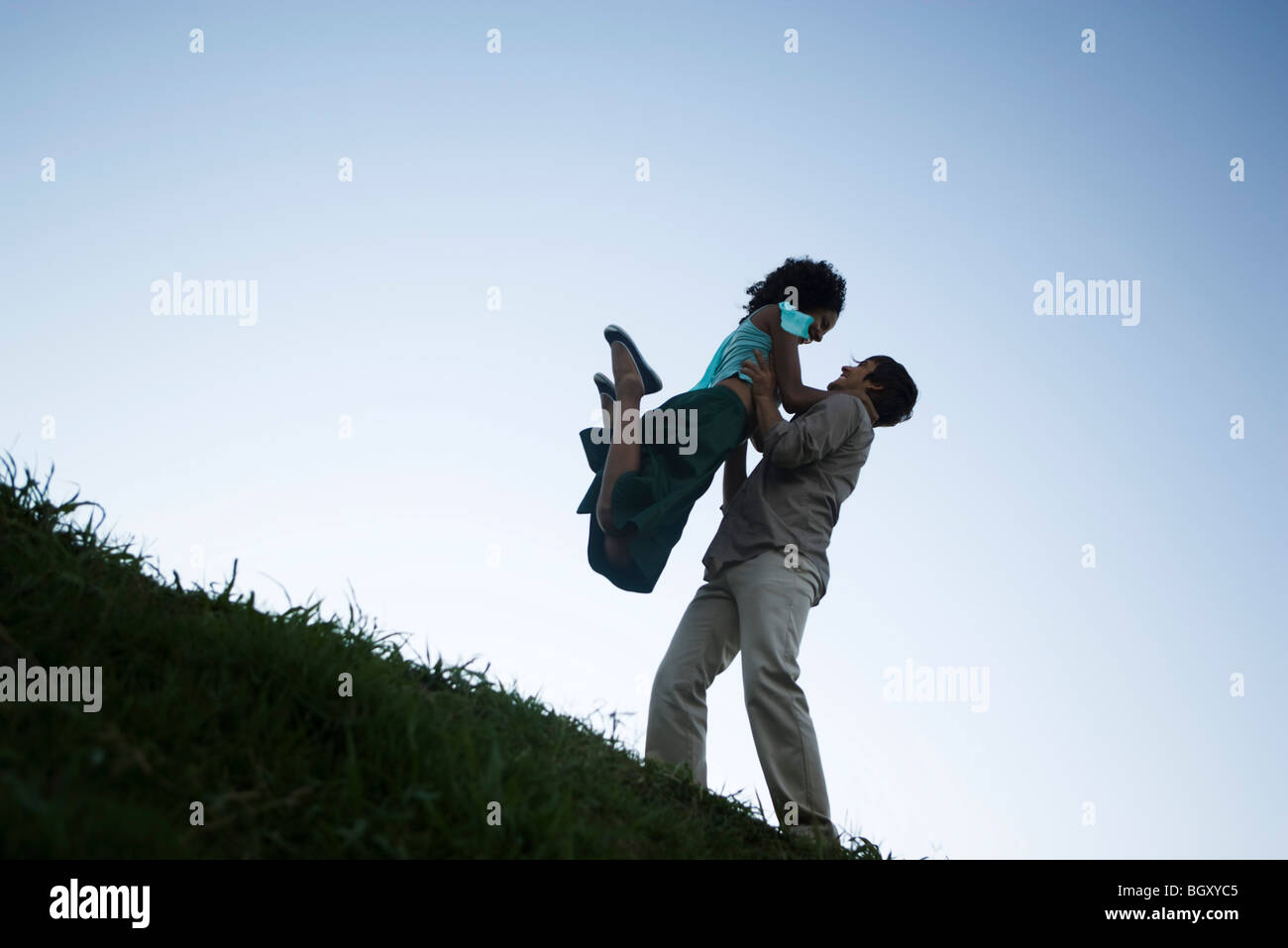 Young couple, woman jumping into man's arms Stock Photo