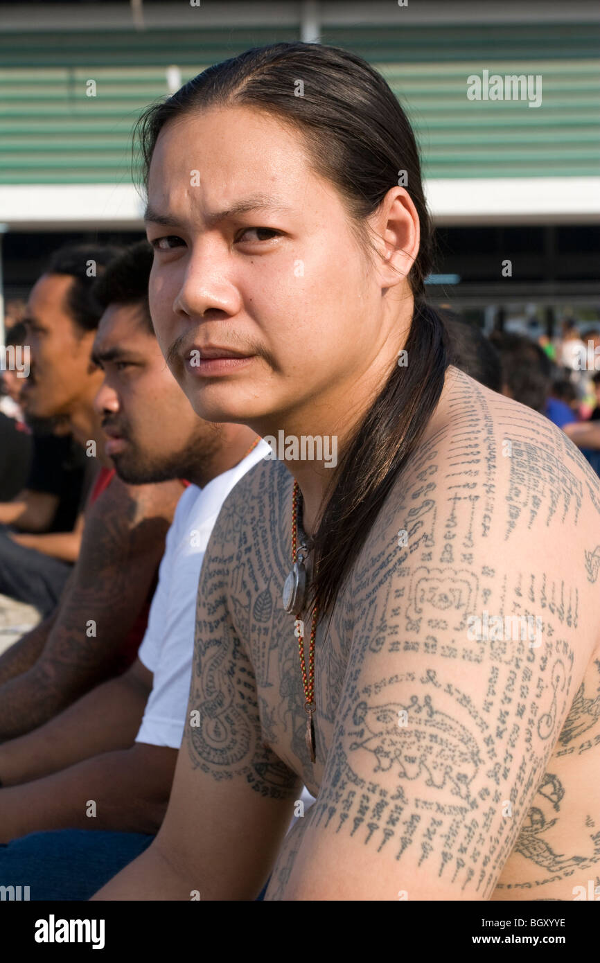 A tattooed devotee at Wat Bang Phra Temple, where Buddhist monks tattoo  magic images and prayers on devotees Stock Photo - Alamy
