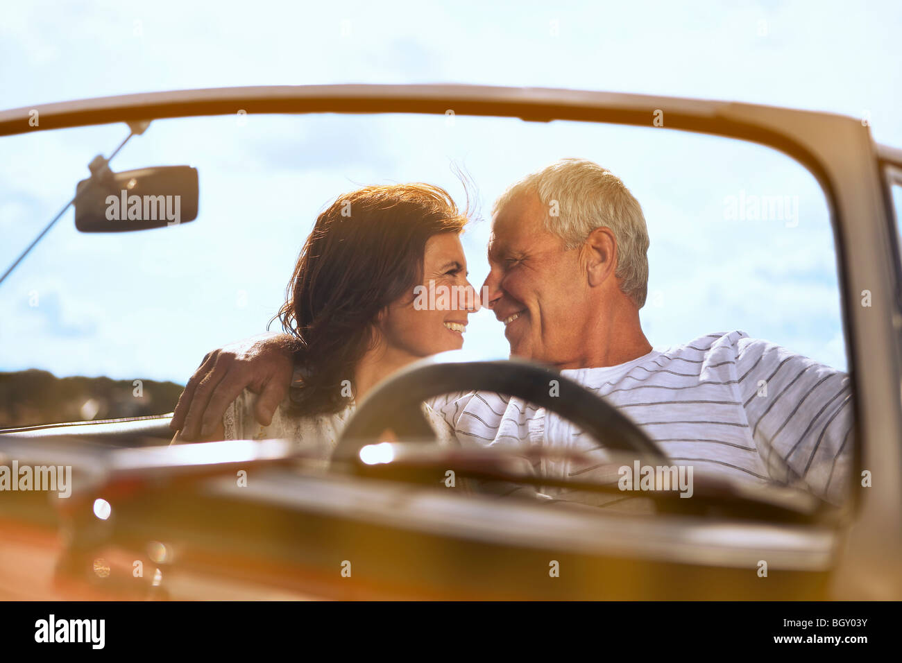 Couple in car, about to kiss Stock Photo