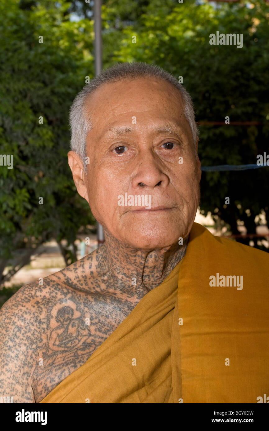 An old monk at Wat Bang Phra, a temple where Buddhist monks tattoo magic  images and prayers on devotees Stock Photo - Alamy