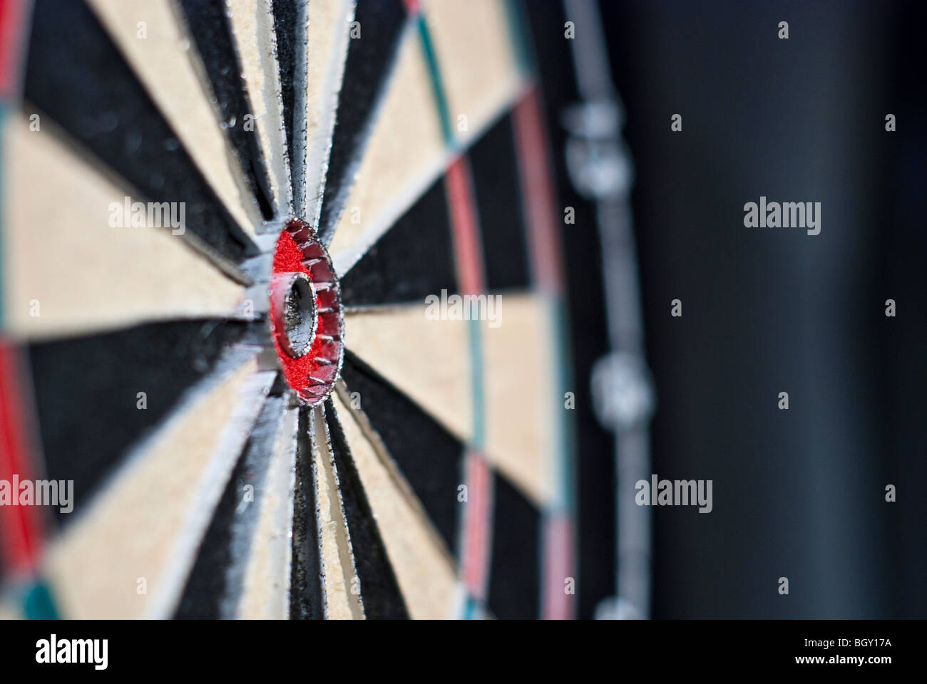 close-up of a bullseye of a dartboard, taken from an angle with shallow depth of field Stock Photo
