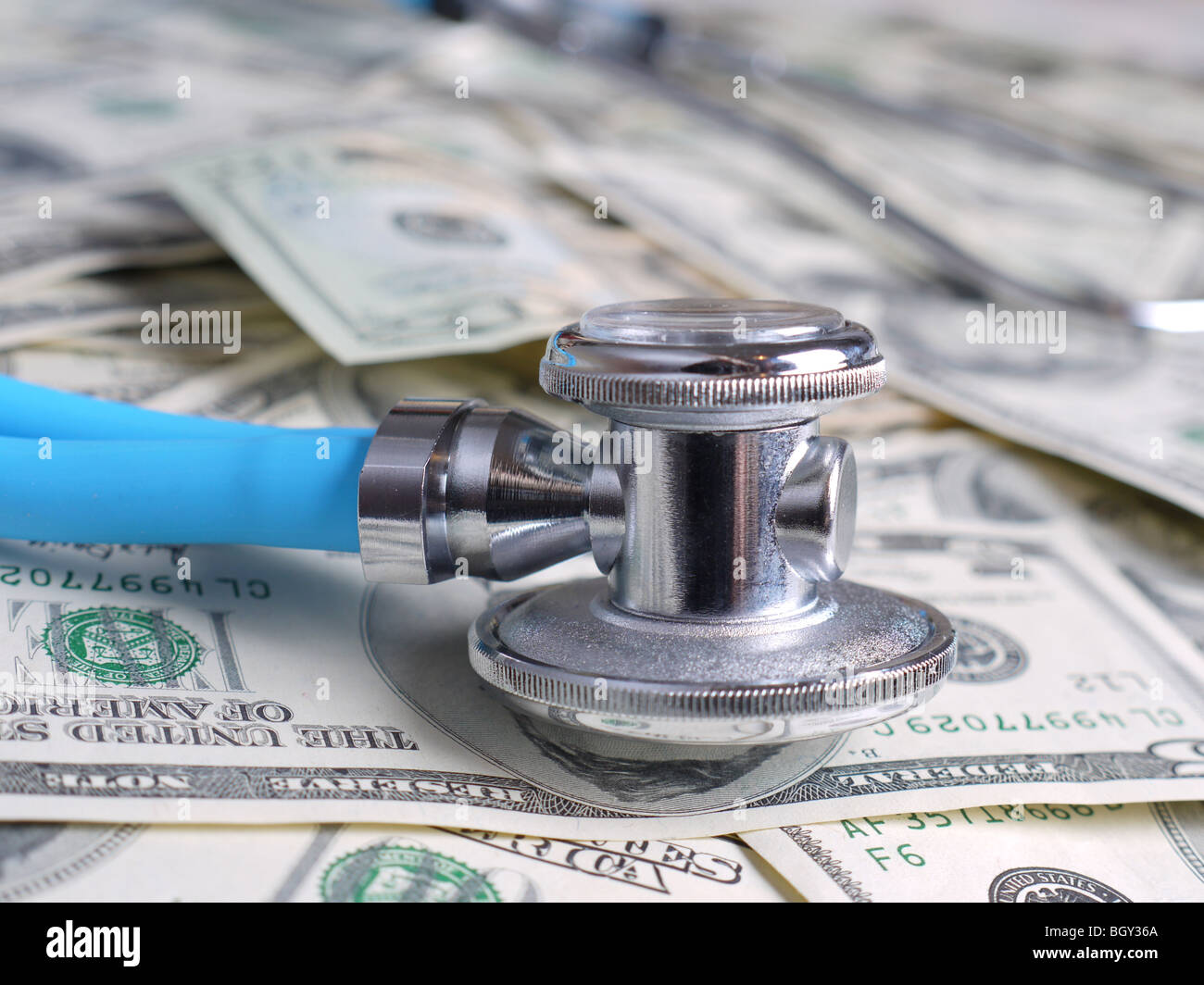 Stethoscope on pile of american dollar banknotes Stock Photo