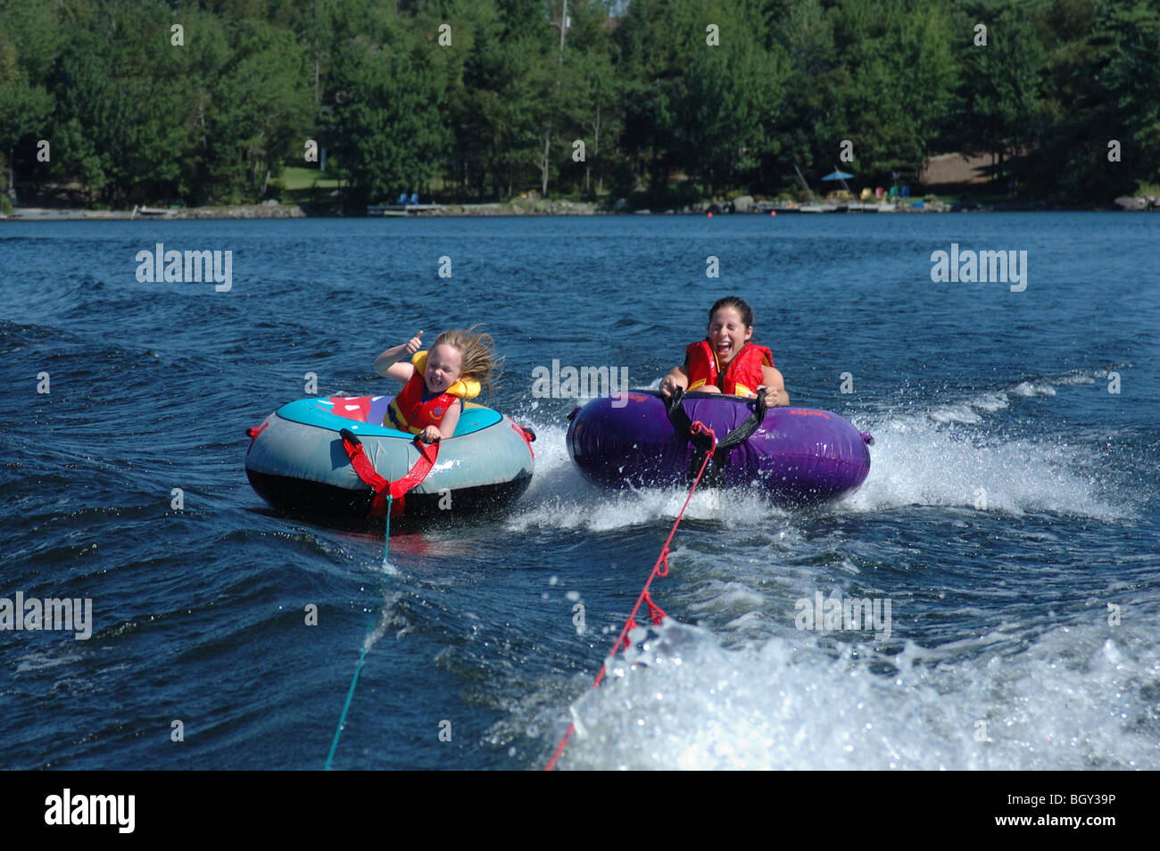 Tubing behind a speed boat Stock Photo Alamy