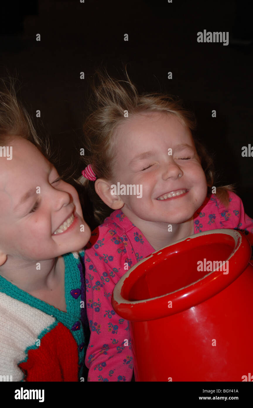 Two young girls having their hair blown at a the Ontario Science Centre Stock Photo