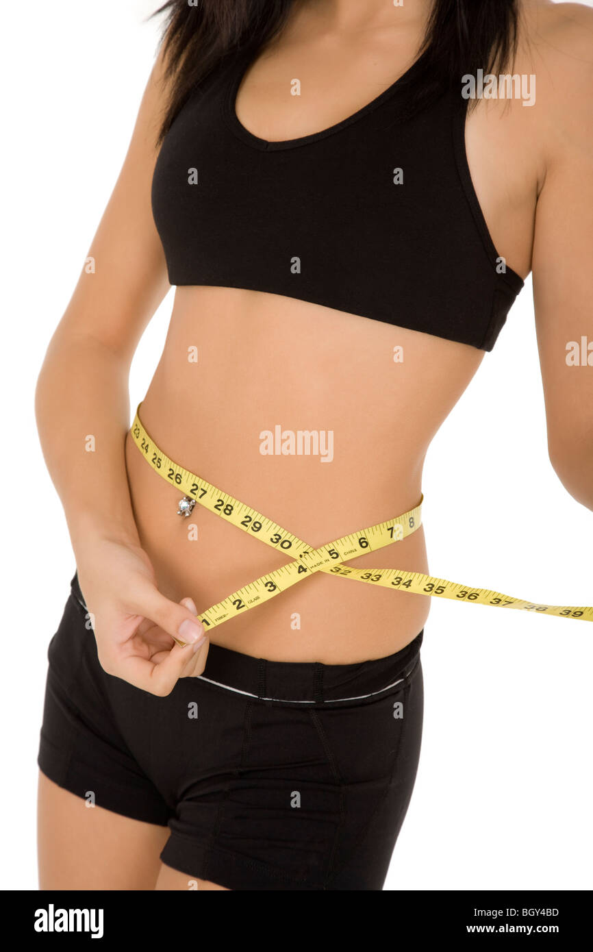 Slender woman measuring her waist with metric tape measure after a diet,  isolated 16406784 PNG