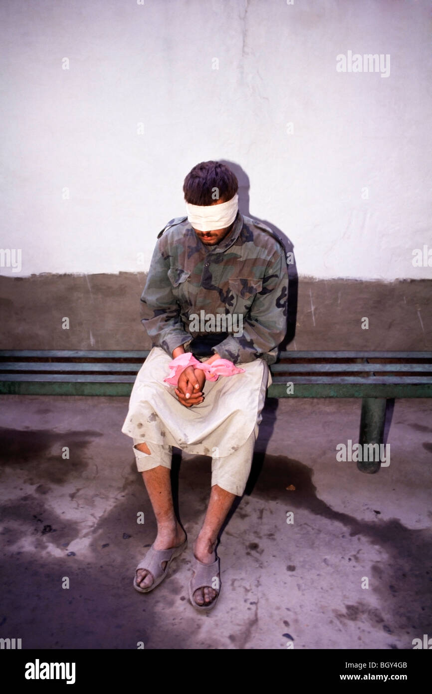 A blindfolded Afghan man at a Russian army base in Pyandsh, Tajikistan after being caught smuggling guns into Tajikistan Stock Photo