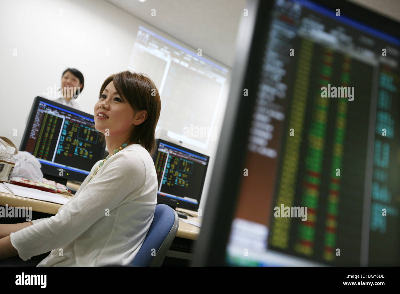Young woman at the 'Advanced' class in learning stocks and shares, at the Nagoya Financial School, Nagoya city, Japan Stock Photo