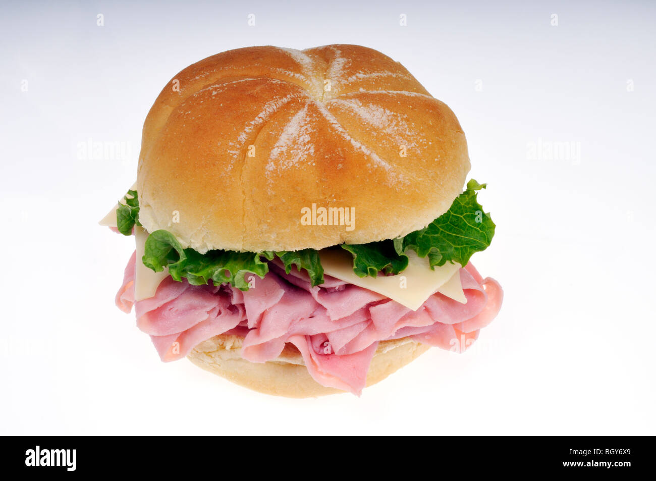 Ham and swiss cheese with lettuce sandwich on white bulkie roll on a white background cutout. Stock Photo