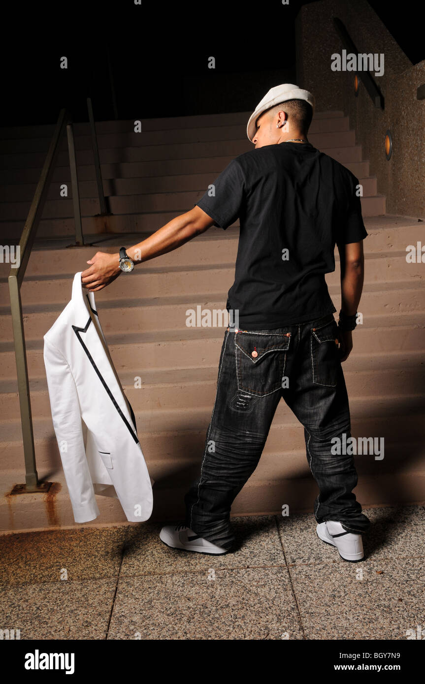 African American hip hop man holding jacket Stock Photo