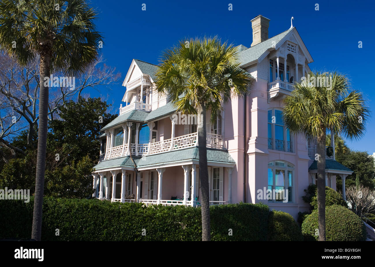 Large pink house with porches and Palmetto trees, Charleston, South Carolina, United States of America. Stock Photo