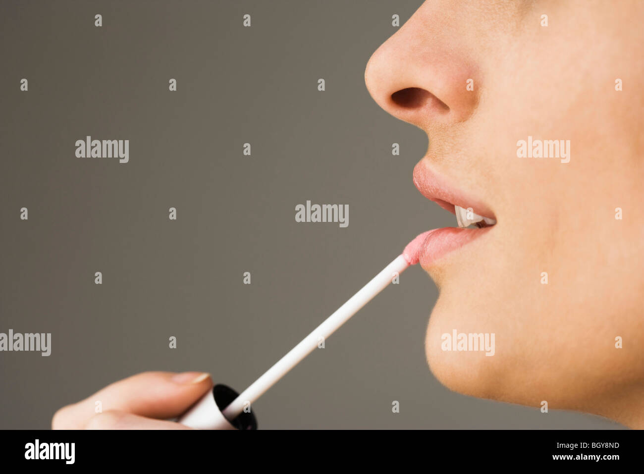 Applying lipgloss with lip brush Stock Photo Alamy