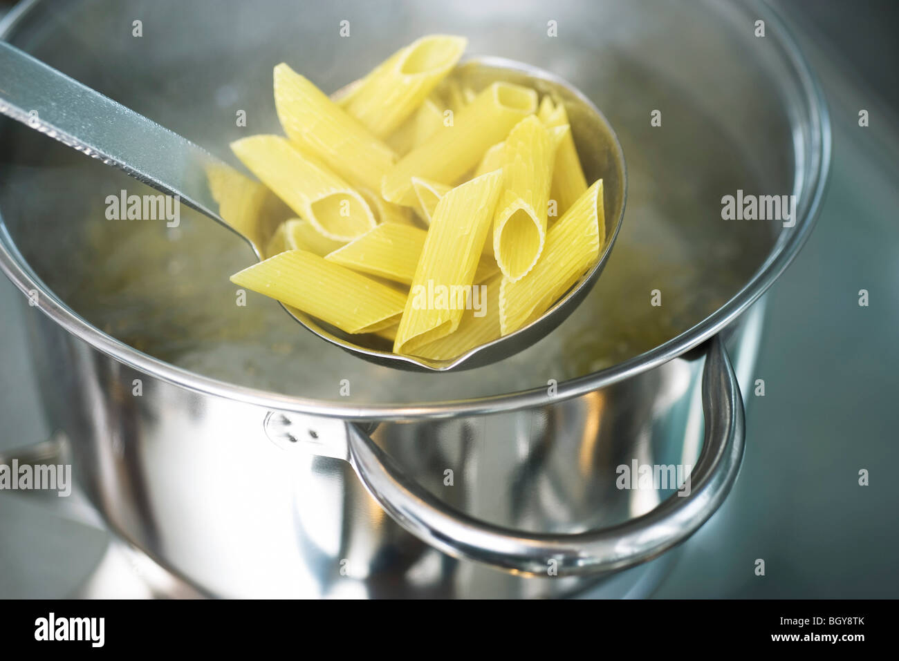 Cooking penne pasta Stock Photo