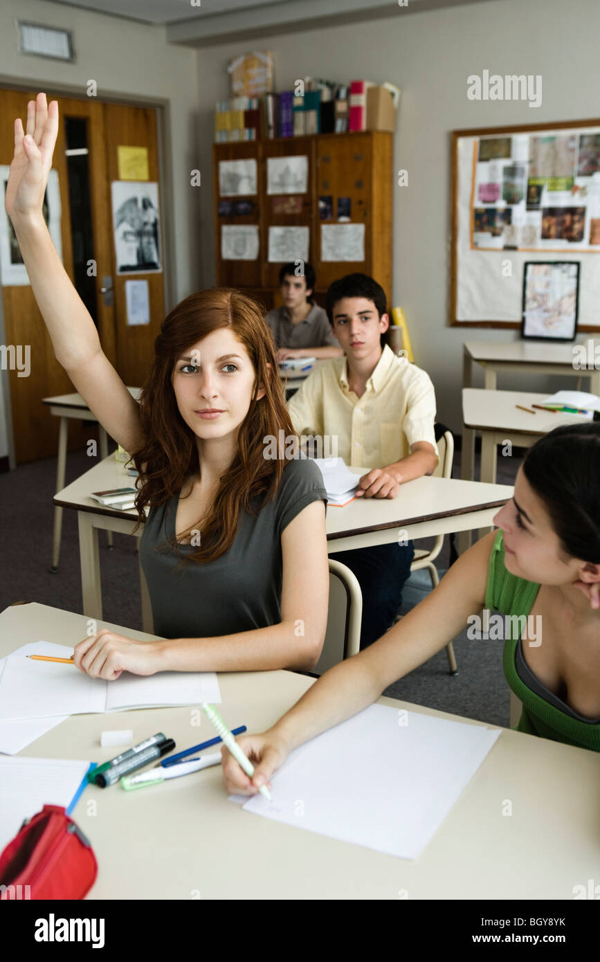 High school student raising hand in class Stock Photo