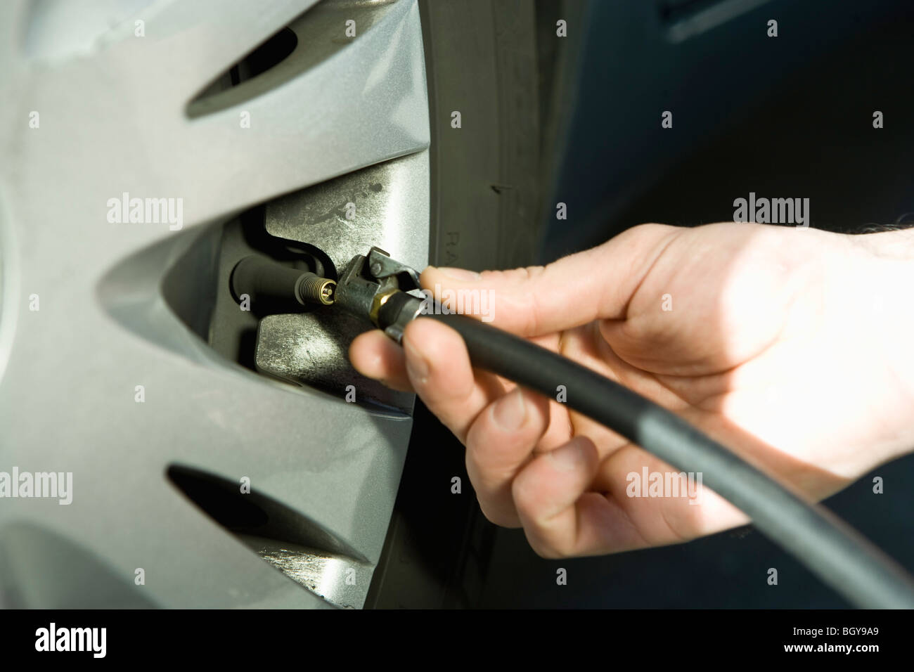 Inflating vehicle tire using air pump hose Stock Photo Alamy