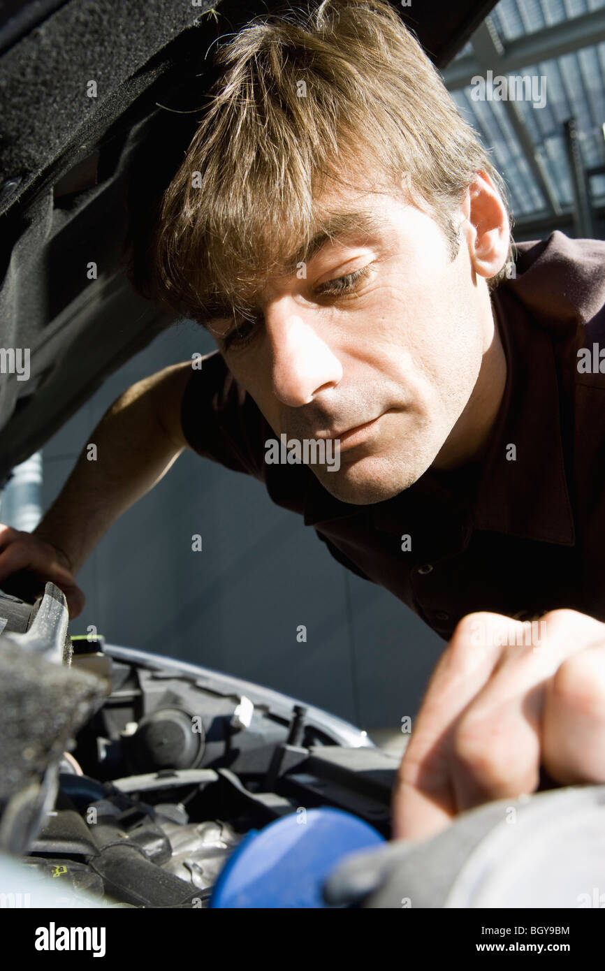Mechanic working on car engine Stock Photo