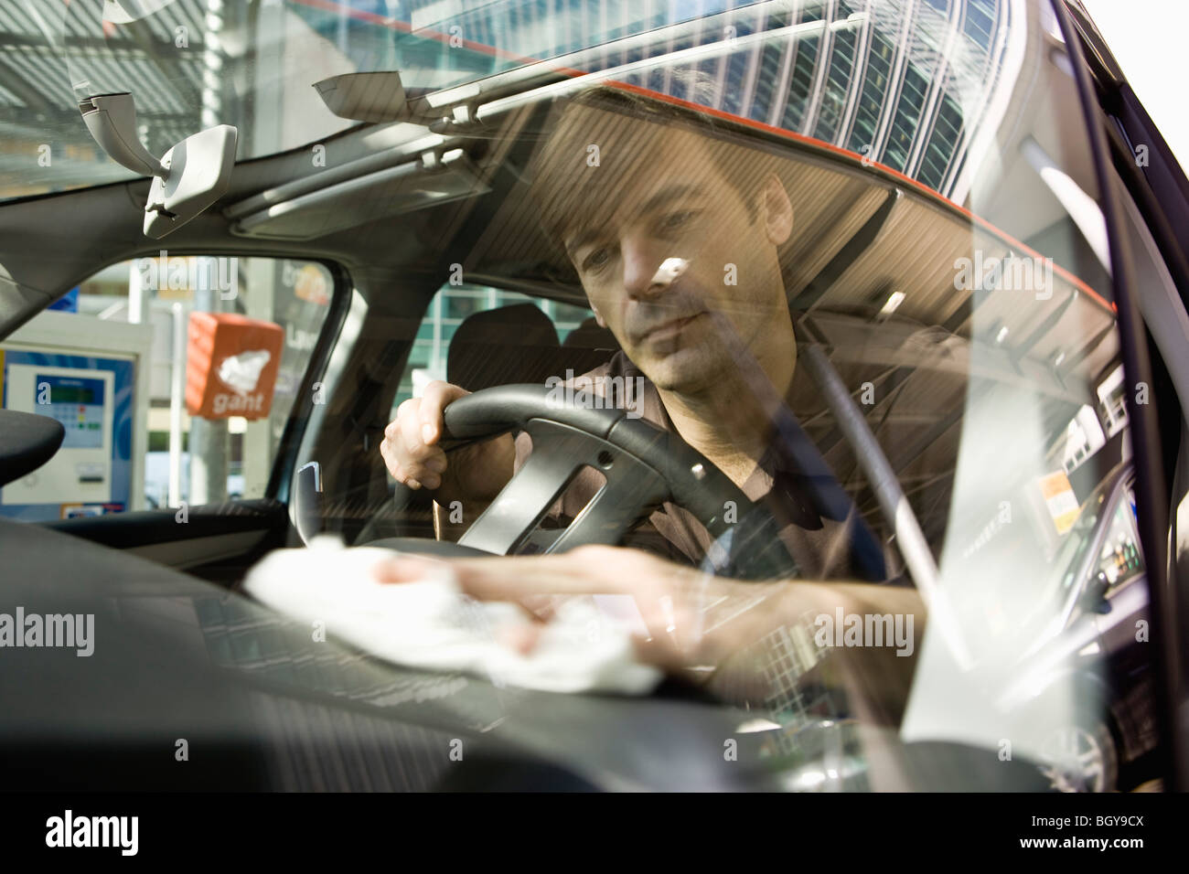 Man cleaning car dashboard Stock Photo