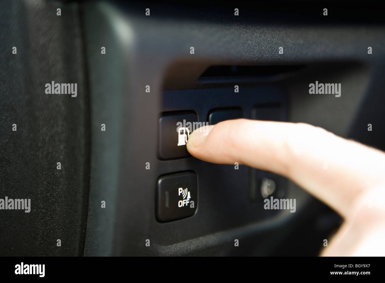 Pressing gas tank button on dashboard keypad Stock Photo Alamy
