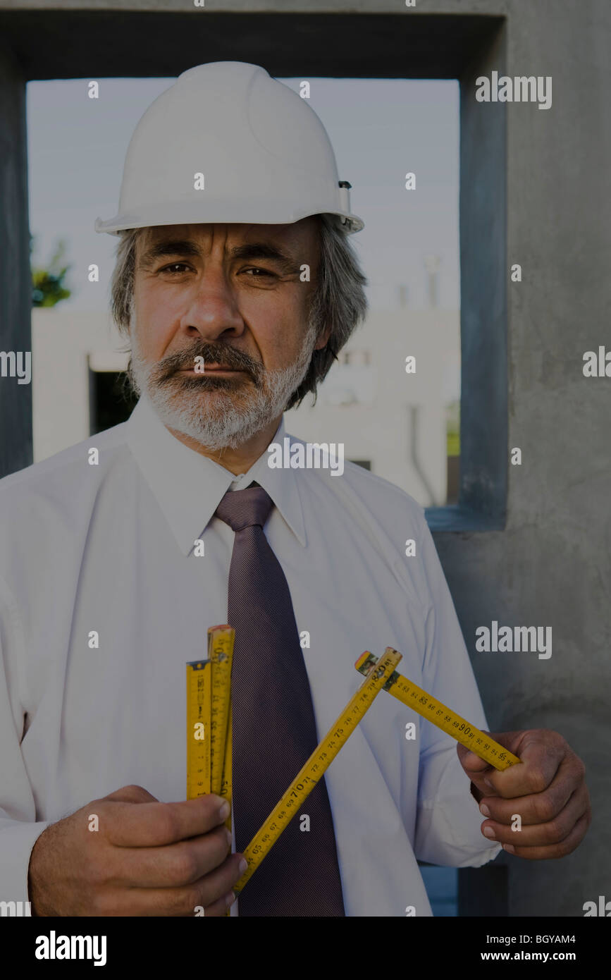 Construction supervisor holding folding ruler, portrait Stock Photo