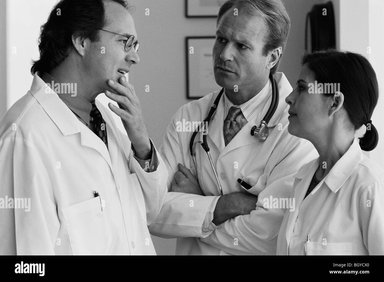 Three doctors talking Stock Photo