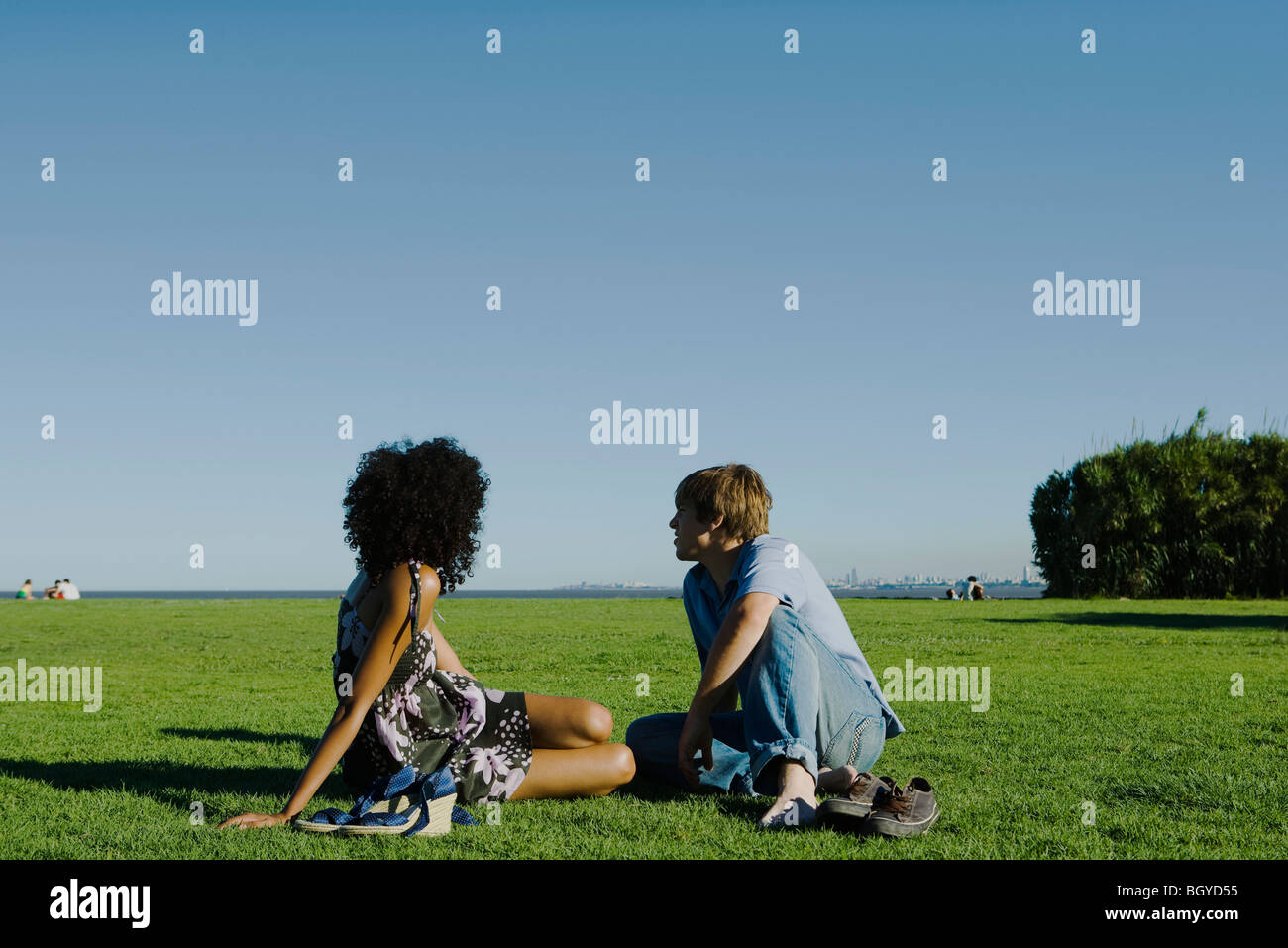 Young couple relaxing together in park Stock Photo - Alamy