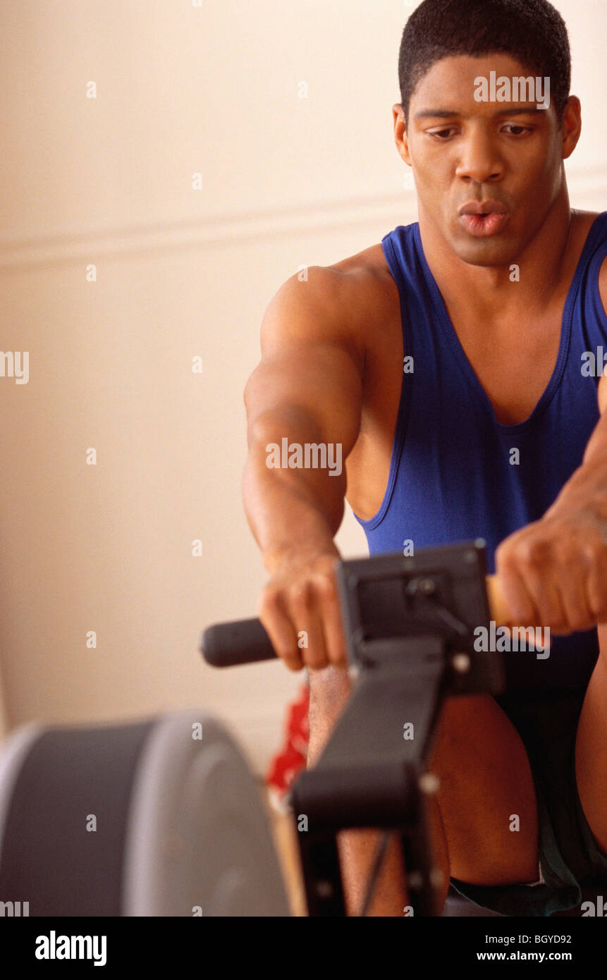 Man on exercise machine Stock Photo
