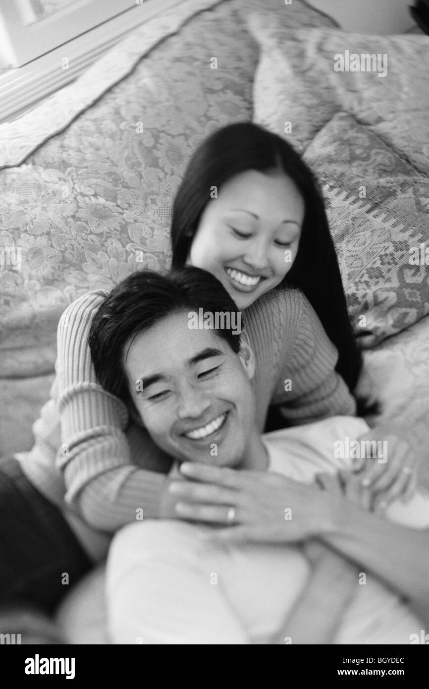 Couple embrace on couch Stock Photo