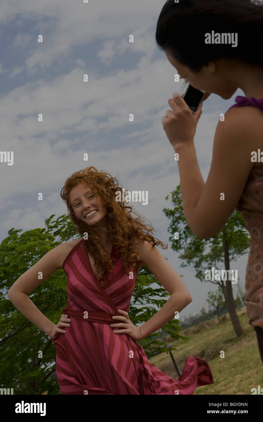 Young woman being photographed by friend Stock Photo Alamy