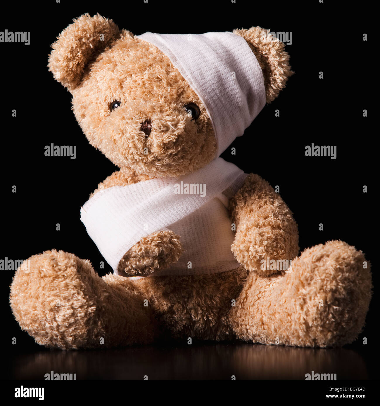 Injured Teddy Bear wrapped in bandage Stock Photo
