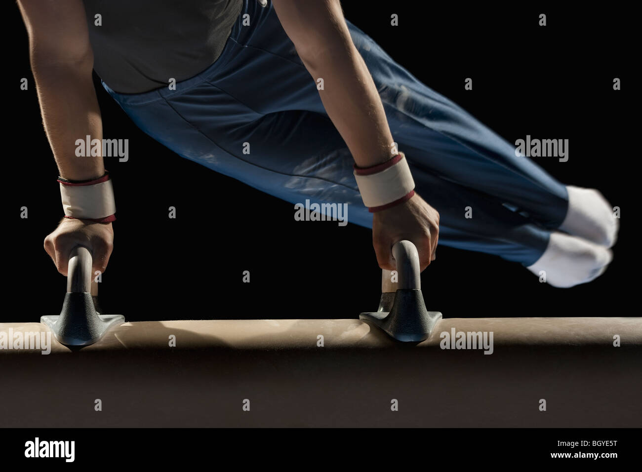 Gymnast swinging on pommel horse Stock Photo