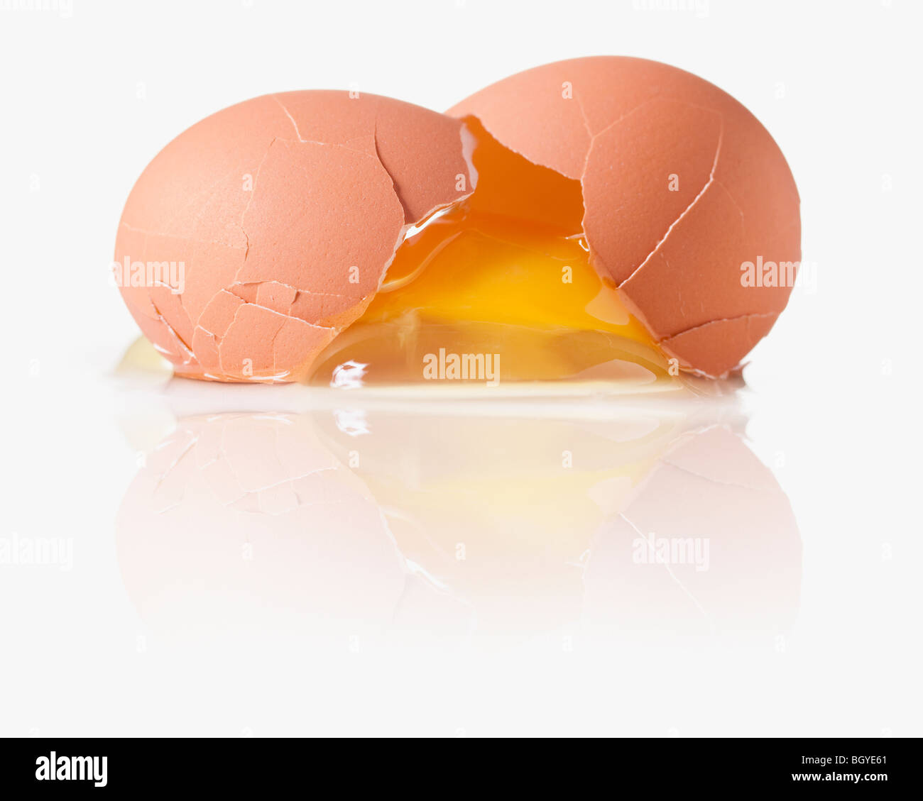 Cracked egg with a shattered yoke Stock Photo