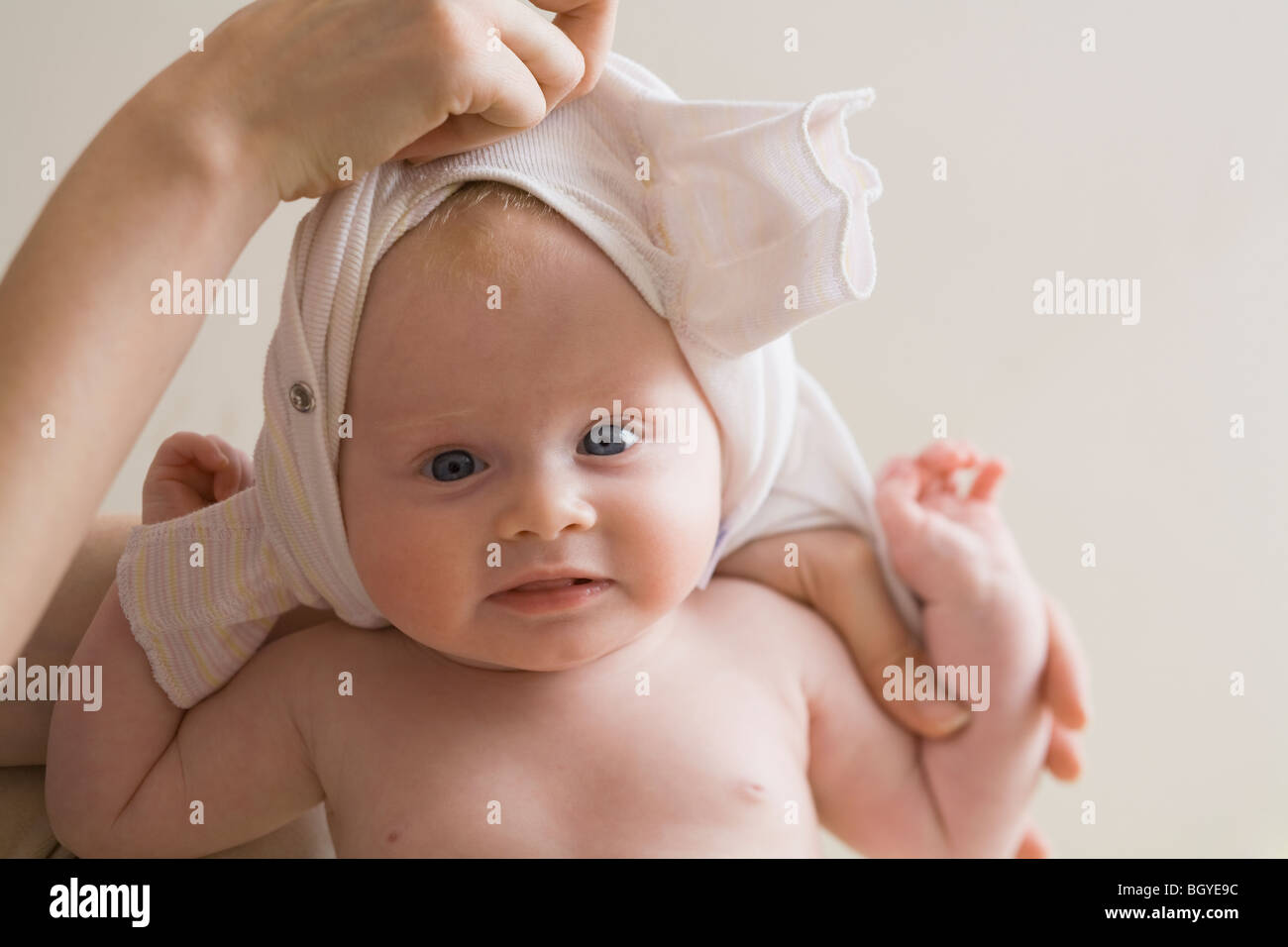 Hand changing baby's clothes Stock Photo Alamy