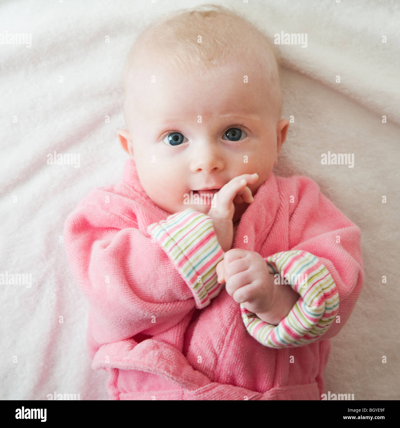 Portrait of baby girl in pink robe Stock Photo Alamy