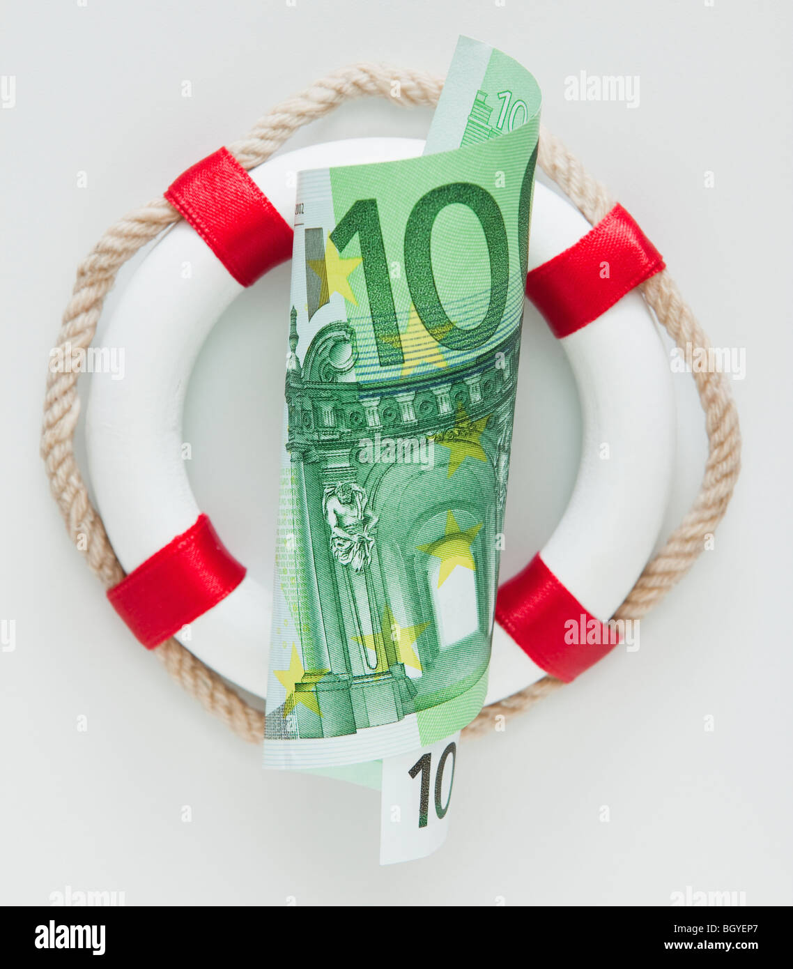 Ring bouy behind European currency Stock Photo