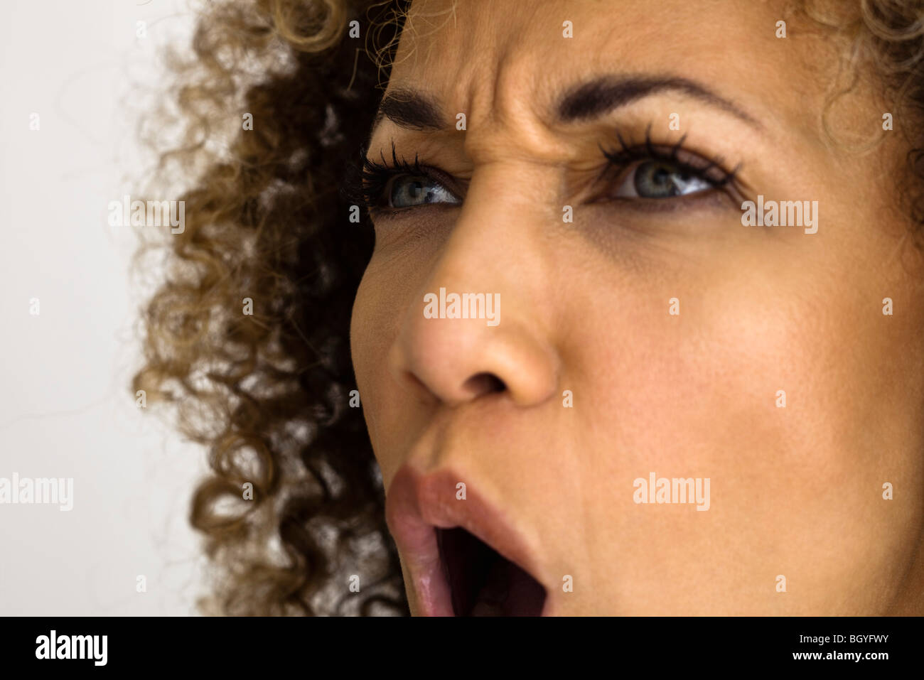 Woman furrowing brow, shouting , close-up Stock Photo