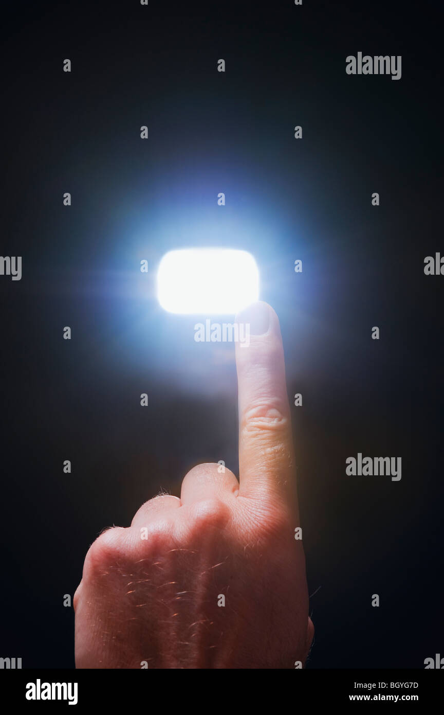 Finger pointing at light Stock Photo